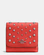 COACH®,SMALL WALLET IN POLISHED PEBBLE LEATHER WITH OMBRE RIVETS,Leather,Silver/Deep Coral,Front View