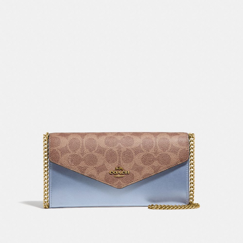 Coach envelope clutch in leather and coated canvas with logo