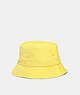 COACH®,REVERSIBLE SIGNATURE NYLON BUCKET HAT,Polyester,Yellow,Front View