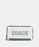 COACH®,LONG ZIP AROUND WALLET IN SIGNATURE CANVAS WITH VARSITY MOTIF,Signature Coated Canvas,Mini,Silver/Chalk/Indigo,Front View