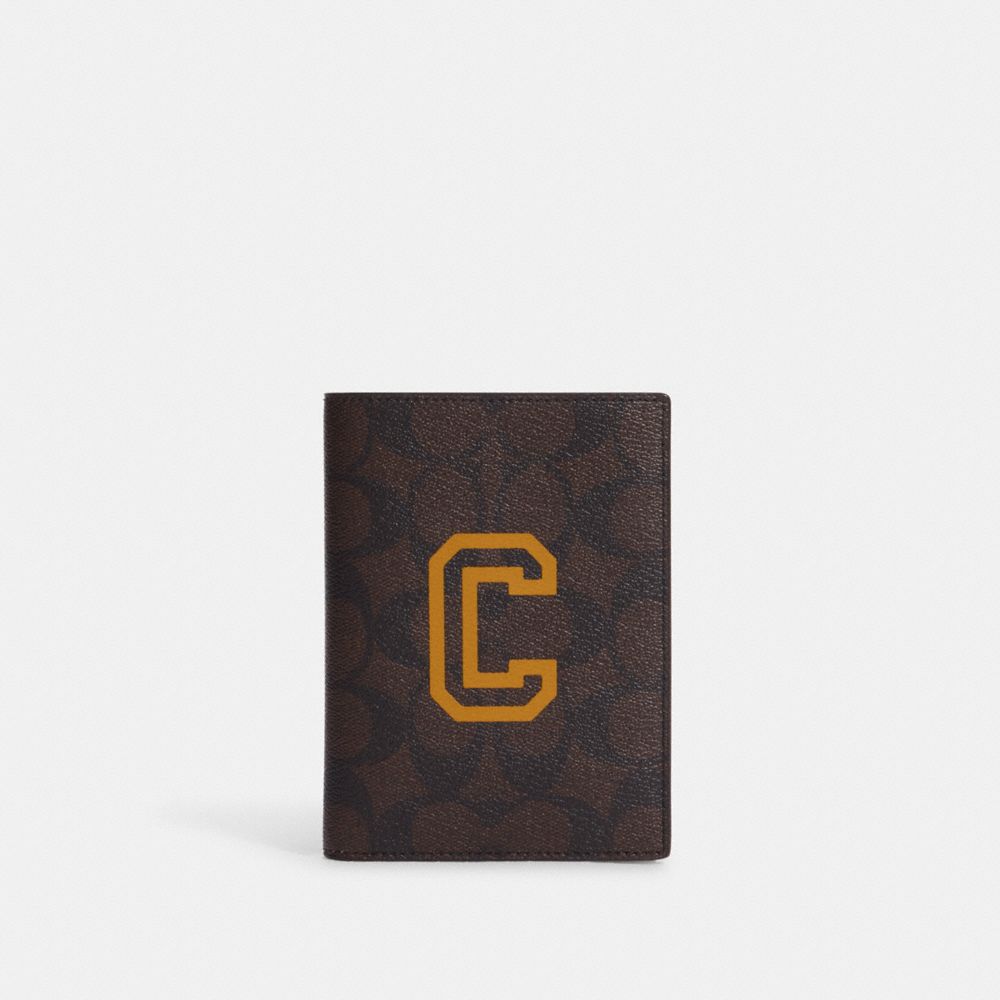 COACH OUTLET® Passport Case In Signature Canvas With Varsity Motif