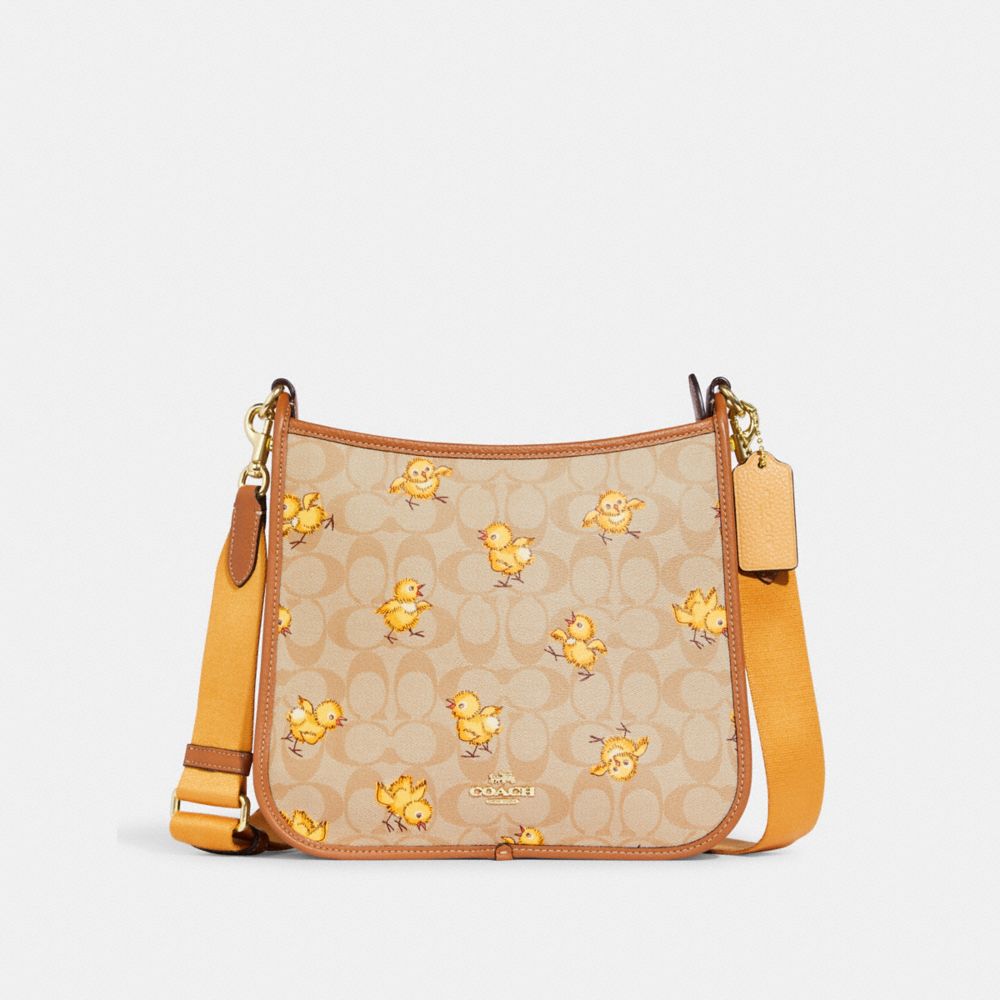 COACH® | Dempsey File Bag In Signature Canvas With Tossed Chick Print