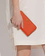 COACH®,ACCORDION ZIP WALLET,Polished Pebble Leather,Mini,Brass/Sun Orange,Detail View