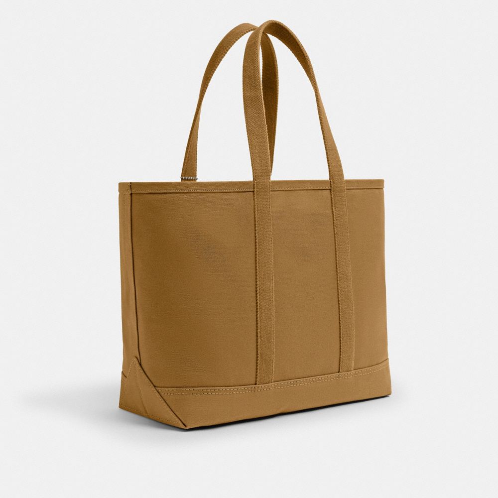 COACH®,Utility Tote,Leather,Cotton,Canvas,Tote,Logo,Word Embellishment,Sustainable,Casual,Brown,Angle View