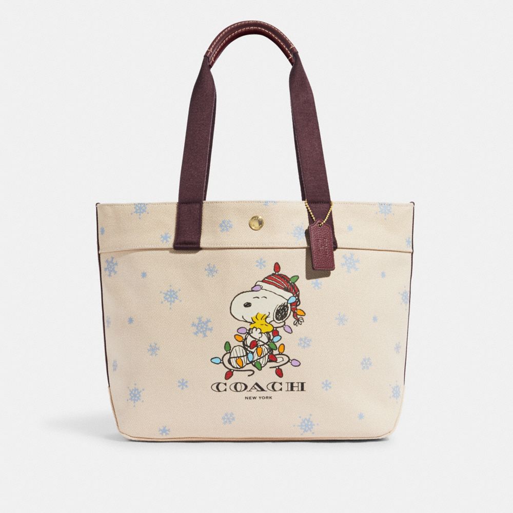COACH® | Coach X Peanuts Tote In Canvas With Snoopy Ice Skate Motif