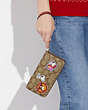 Long portefeuille à zip-contour Coach X Peanuts en toile Signature avec renforts