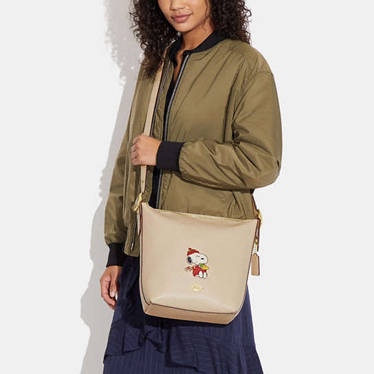 COACH® | Coach X Peanuts Val Duffle With Snoopy Cuddle Motif