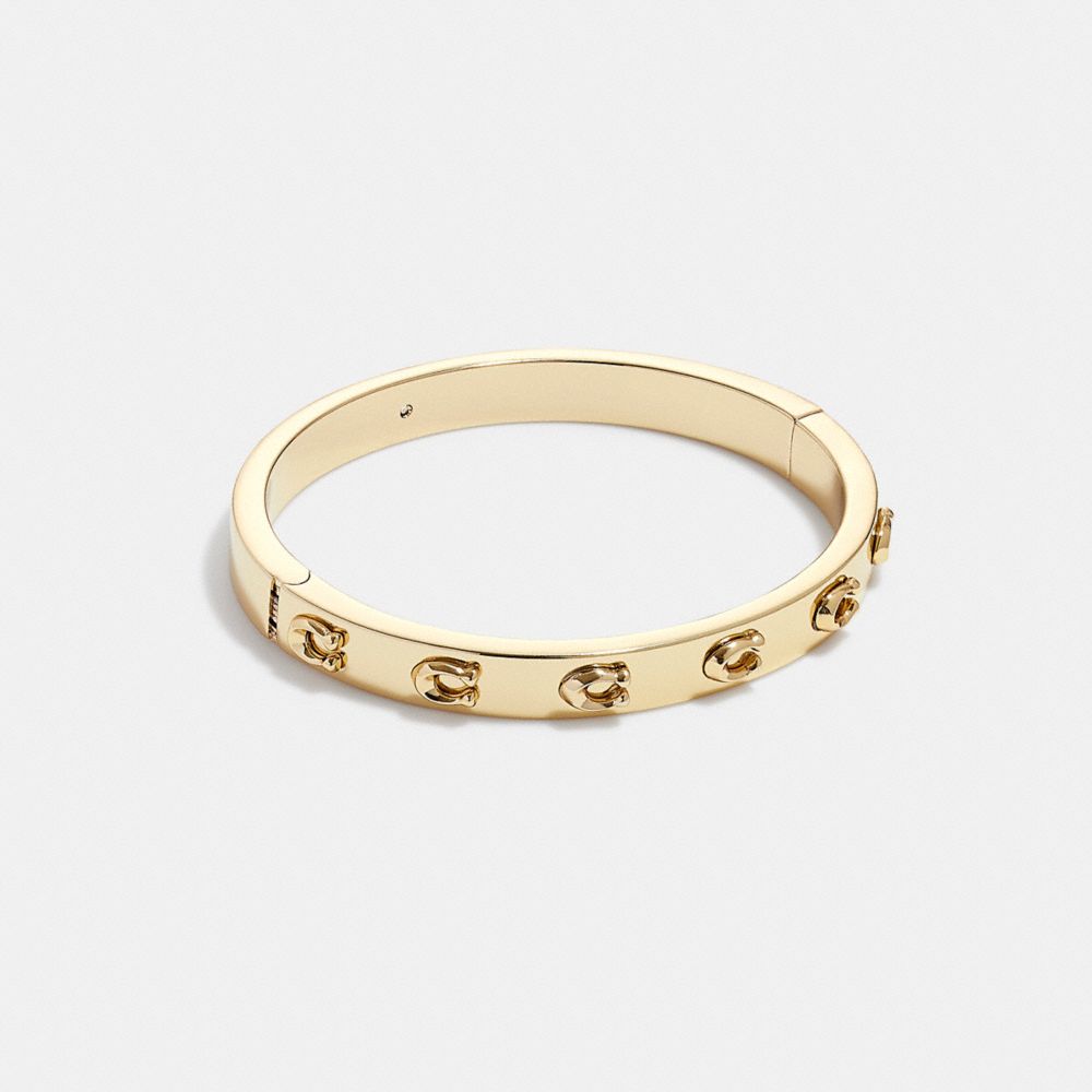 Coach Pegged Signature Hinged Bangle In Gold