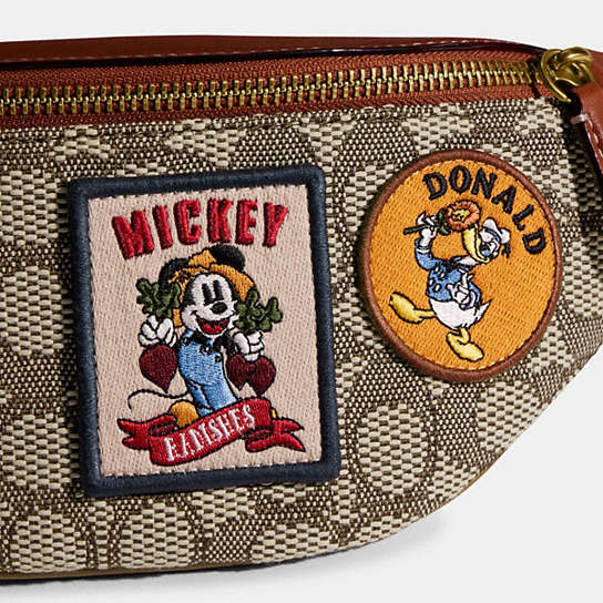 COACH®: Disney X Coach Charter Belt Bag 7 In Signature Textile Jacquard  With Patches