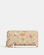 COACH®,LONG ZIP AROUND WALLET IN SIGNATURE CANVAS WITH NOSTALGIC DITSY PRINT,Gold/Light Khaki Multi,Front View