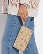 COACH®,LONG ZIP AROUND WALLET IN SIGNATURE CANVAS WITH NOSTALGIC DITSY PRINT,Gold/Light Khaki Multi,Detail View