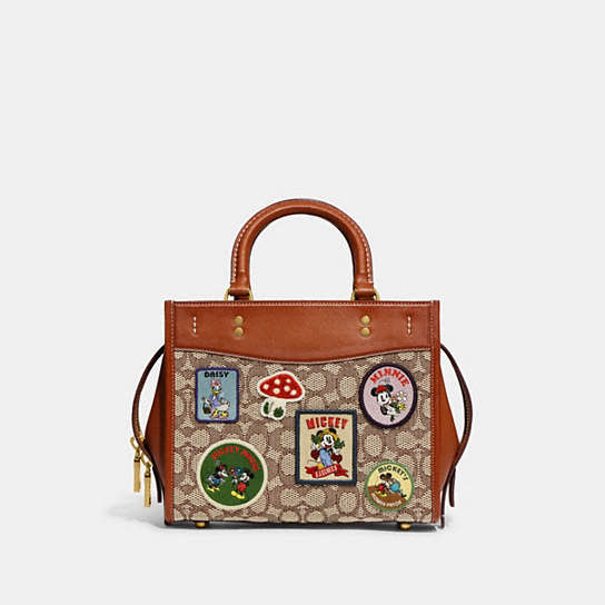 COACH®: Disney X Coach Rogue 25 In Signature Textile Jacquard With Patches