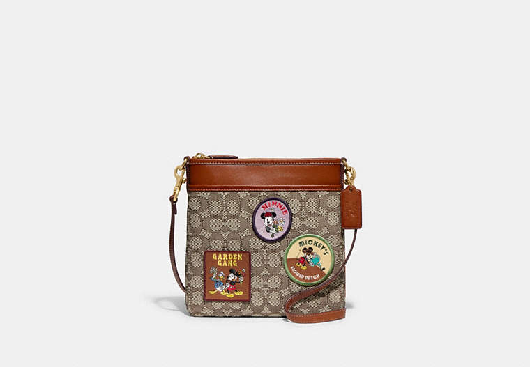 COACH®,DISNEY X COACH KITT MESSENGER CROSSBODY IN SIGNATURE TEXTILE JACQUARD WITH PATCHES,Jacquard,Medium,Brass/Cocoa Burnished Amber,Front View