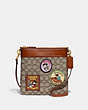 COACH®,DISNEY X COACH KITT MESSENGER CROSSBODY IN SIGNATURE TEXTILE JACQUARD WITH PATCHES,Jacquard,Medium,Brass/Cocoa Burnished Amber,Front View