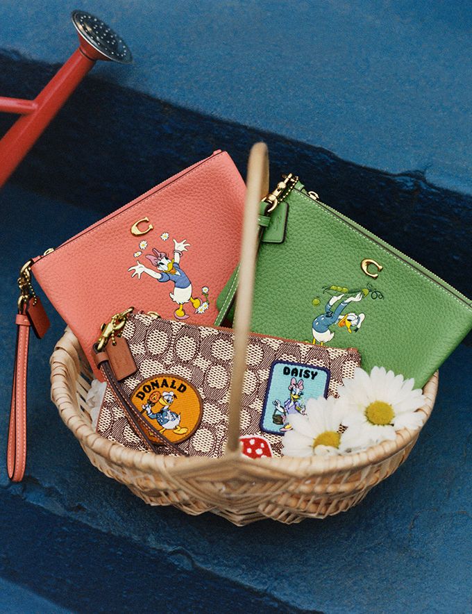 COACH®: Disney X Coach Small Wristlet In Regenerative Leather With Donald  Duck