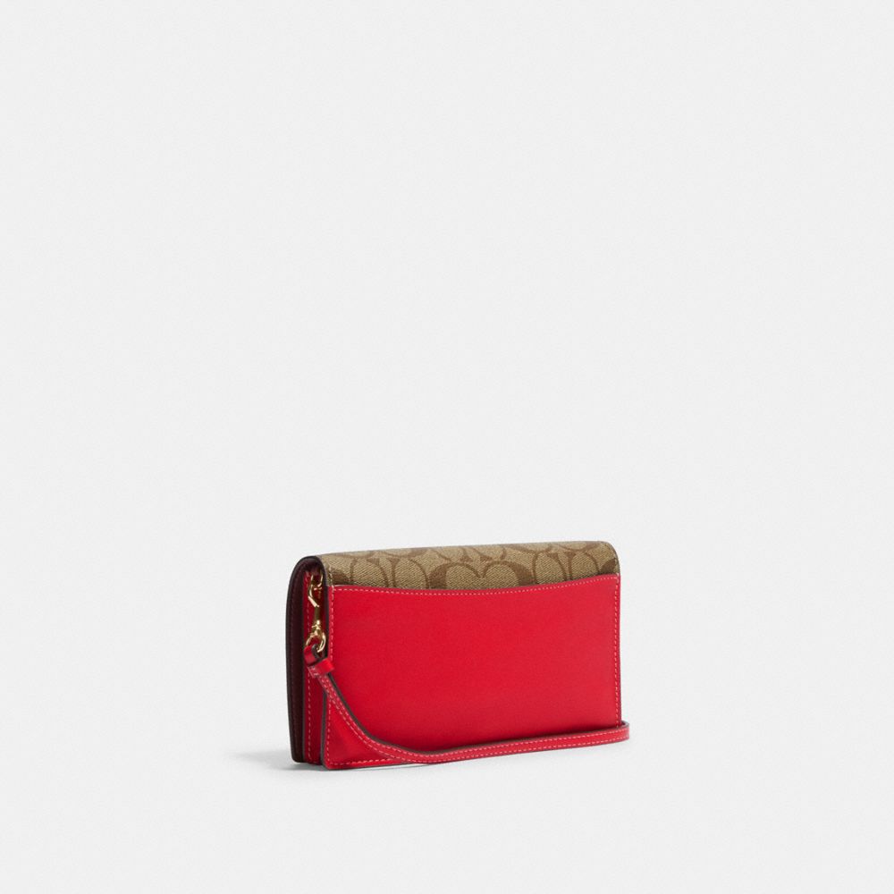 COACH®,Anna Foldover Clutch Crossbody In Signature Canvas With Strawberry,,Angle View