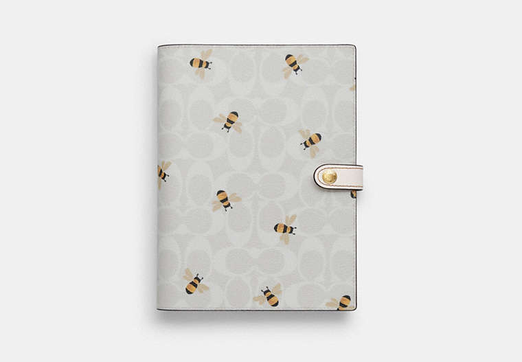 COACH®,NOTEBOOK IN SIGNATURE CANVAS WITH BEE PRINT,Gold/Chalk/Glacier White Multi,Front View