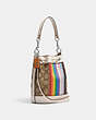 COACH®,MINI DEMPSEY BUCKET BAG IN SIGNATURE JACQUARD WITH RAINBOW STRIPE AND COACH PATCH,Jacquard,Silver/Khaki Multi,Angle View