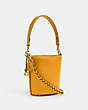 COACH®,DAKOTA BUCKET BAG 16 WITH BRAID,Glovetanned Leather,Small,Brass/Buttercup,Angle View