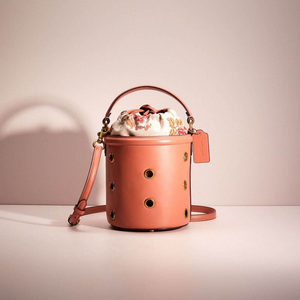 Coach Restored Drawstring Bucket Bag With Grommets In Brass/light Peach