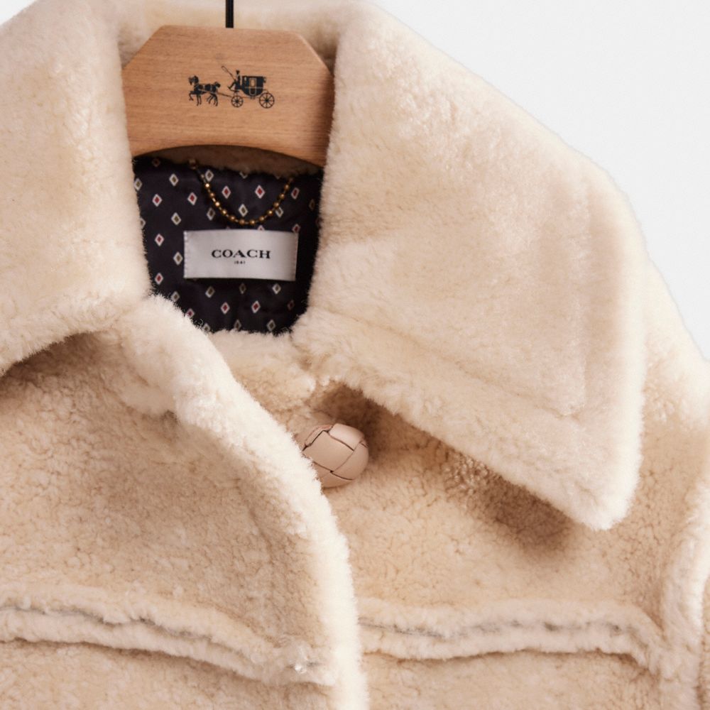 Shop Coach Restored Short Shearling Coat With Printed Lining In Vintage White